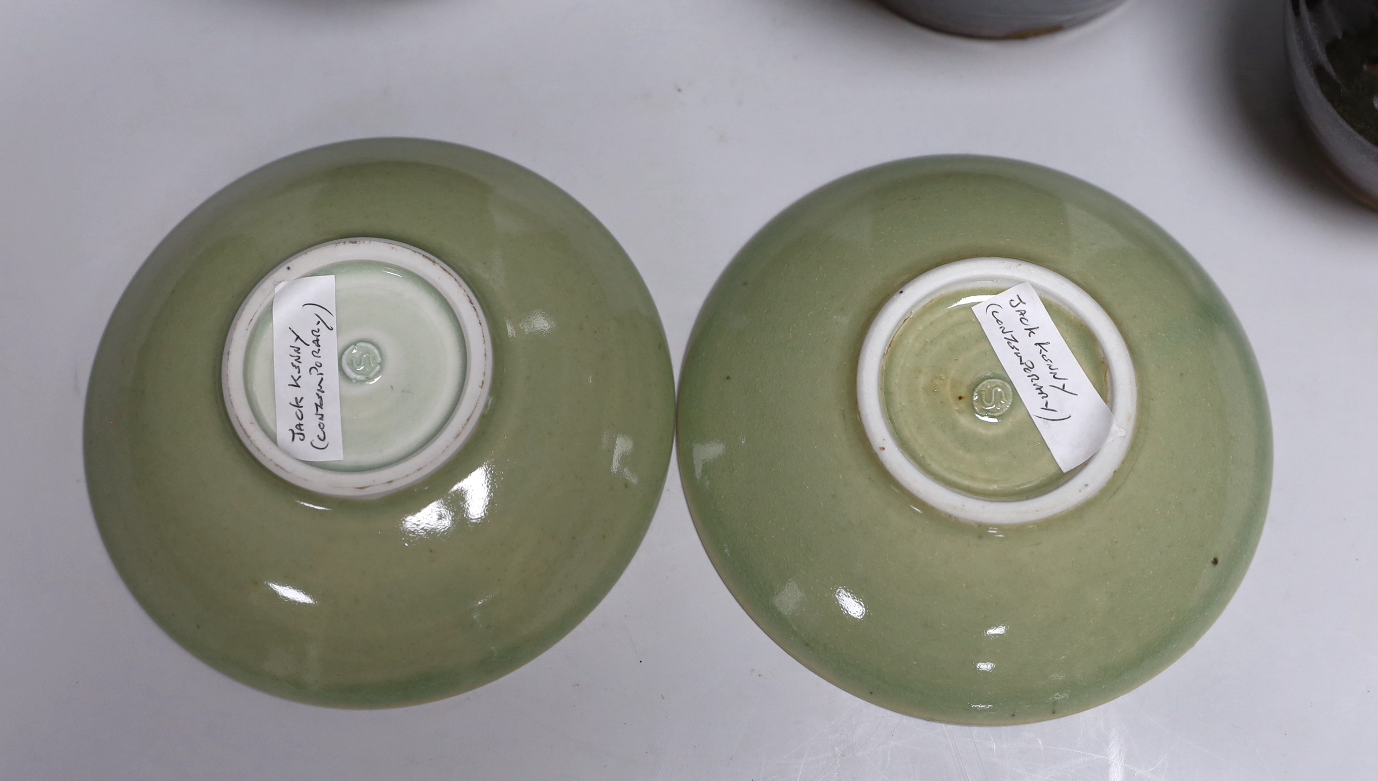 Two green glazed dishes by Jack Kenny, two dark glazed vases, a similar jug and a small bowl, tallest 26cm high